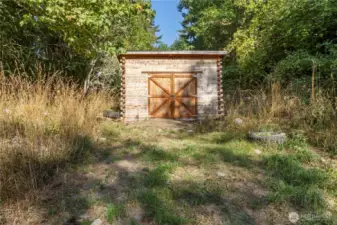 On lower lot 16x24 cedar shop/garage w/ 5” thick solid cedar walls & walk-in temp-controlled root cellar/cooler