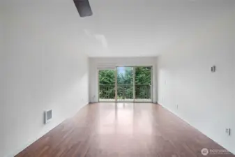 Spacious living area with updated flooring and natural light.