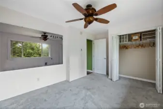 Generous primary bedroom with large windows.