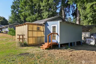 Back of the greenhouse and the separate entrance to the studio area of the detached garage.