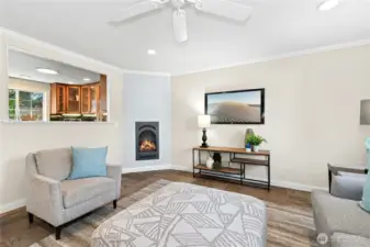 Gas fireplace and pass-through opening to kitchen. Perfect space for gatherings.