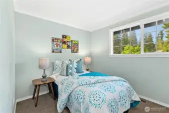 Upstairs front bedroom with carpeted floor ideal for restful nights.