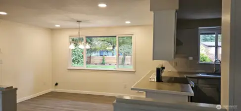 Formal dining room with wood stove and opens to kitchen with eating area too