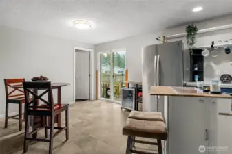 Kitchen opens to dining and sliding door to patio and backyard