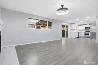 Large family room and dining area with wood burning fireplace.