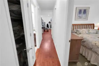 Hallway on upper floor has engineered plank hardwood.