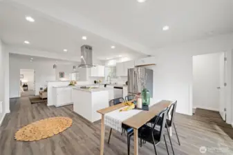 The openness of the kitchen and dining and living areas are great for entertaining! The door to the right leads to the family room in the basement.