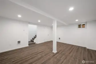 Another view of the lower level with the under stair storage room that houses the new electric hot water heater.