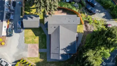 Looking down on the home and shop with the evergreens surrounding it.