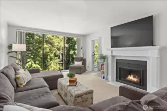 Living room w/cozy fireplace and beautiful wooded outlook