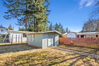 Included shed contains cabinets, workbench & shelving for gardening and storage needs
