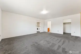 Primary suite with 3/4 bath and generous walk-in closet.