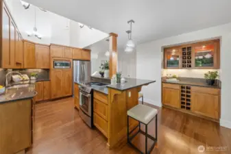 This thoughtfully designed kitchen features a built-in bar with wine storage and room for bar seating—ideal for casual conversation or keeping the chef company while meals come together.