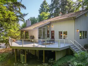 Designed for seamless indoor-outdoor living, the expansive back deck blends forest serenity with comfort and ideal for year-round entertaining.