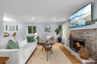 Charming fireplace adds warmth and comfort with stone surround.