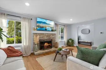 Oversized windows fill the space with natural light, showcasing the beautiful floors.