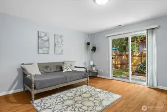 Lower level rec room. Sliding door leads to the back patio.