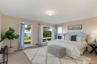 Primary bedroom with access to the back deck and the view.