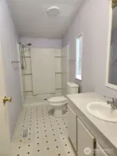 Spacious primary bath with updated walk in shower.