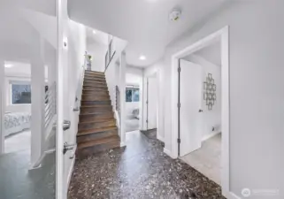 Entry level stairs leading to two downstairs bedrooms and shared bath.
