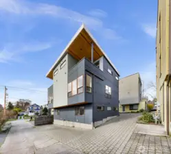 Back of townhome where the off street parking is. The parking spot is directly in back of the unit.