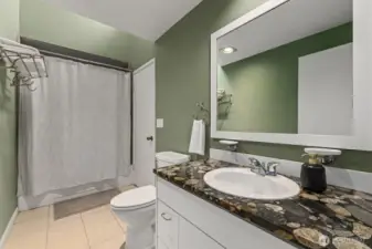 The full bathroom supports both bedrooms upstairs. The vanity is well-appointed.