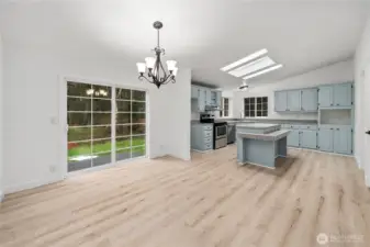 Slider off dining room leads to back deck and over looks small water feature and patio