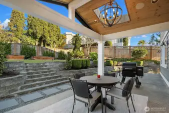 Covered patio exceptional for year round entertaining. Extensive hardscape and also garden beds and fruit trees!