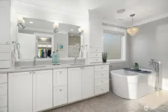 Spacious primary bath with soaking tub, large walk-in shower and walk-in closet.