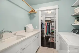 Upstairs laundry room with connection to the hallway and the primary bedroom closet as well.