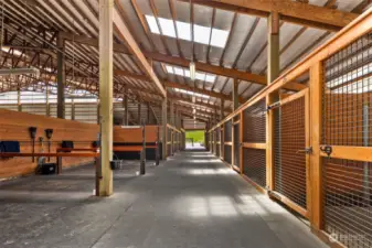 31 interior stalls with custom blanket lockers, one stall is converted to a 12 x 12 fully enclosed Equivibe, 2 rubber matted hot/cold wash racks, 2 oversized vet and farrier cross tie bays, (bay 2 equipped with Drimee Sirocco infrared therapy solarium with heating and cooling)