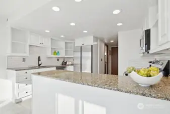 Granite Kitchen countertop and subway style backsplash. refinished cabinet, New SS refrigerator, Stove, Micro oven, and faucet.