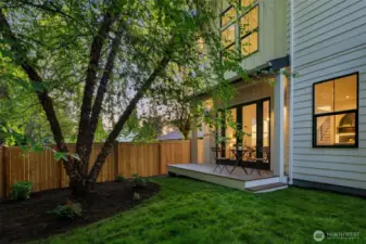 Patio and fully fenced backyard.