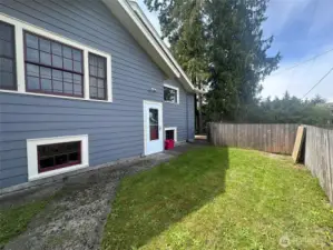 Fenced back area with access to alley parking and garbage can storage.
