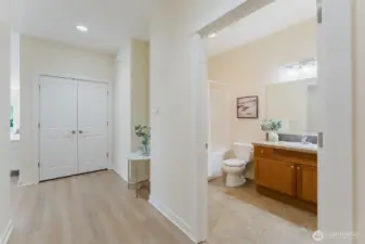 Down the hall, you'll find the first of two full bathrooms, along with a second generous closet—ideal for stashing everything from winter coats to beach towels. Practical storage that keeps life beautifully organized.