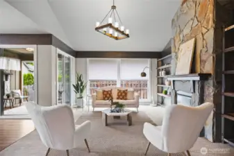 Bright and airy living room with large windows, stylish flooring, built in shelving, and a seamless flow to the main living areas.