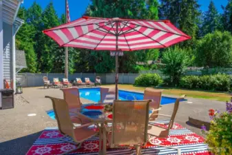 Spacious concrete decking lends to plenty of space for a large patio table and chair set, and adds another dimension of fun to this area.