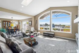Large living room has room for plenty of seating and has bookcases for lots of display area for art, books and more!