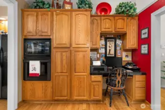 The extended kitchen area boasts hardwood flooring, an in double wall microwave, oven, and pantry sized cabinets.  Imagine a beverage fridge built in below the desk area! This would make a fabulous bar space!