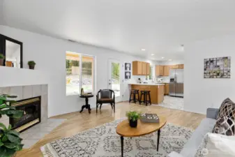 Family Room off the Kitchen features a Gas Fireplace and french door to the backyard and deck.