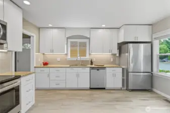 Spacious kitchen with porcelain tile flooring and room to cook, gather, and enjoy