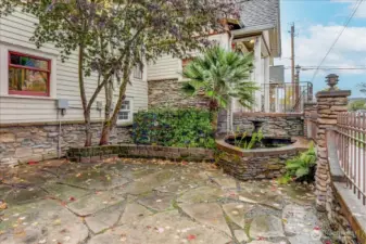 Gated patio with fountain and pond at residential entrance