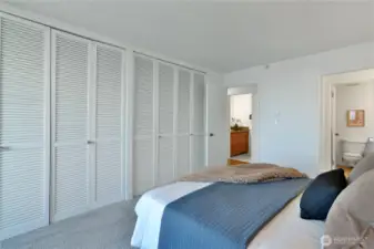 Generous primary bedroom with a wall-to-wall closet