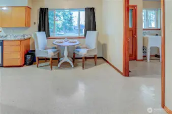 Looking at eating nook  in front of large window looking out to backyard. View is from edge between kitchen and living room.