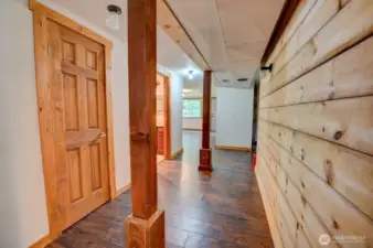 Lower level finished basement - wood-finish support pillars, shiplap wall