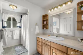 The full bathroom off the hallway has also been refreshed with new tile surround shower, floor and vanity.