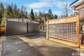 A view from the driveway towards the carport/shop.