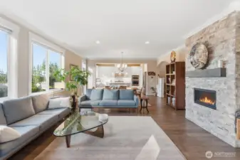 The family room is warm and inviting, highlighted by beautifully wood-wrapped windows that frame the natural light perfectly. Elegant crown molding adds a refined touch, creating a space that feels both cozy and sophisticated.