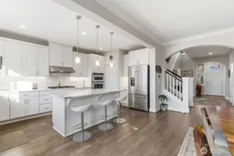 Another view of this amazing kitchen and shows the convenient entry way and entrance to the upper level