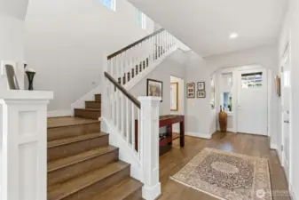 The staircase to the upper level adds architectural charm while providing a seamless transition between living spaces. Its inviting design draws you upward to the private retreat areas of the home.